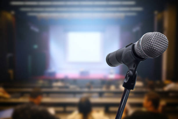 istock Microphone over the blurred business forum Meeting or Conference Training Learning Coaching Room Concept, Blurred background. 1163100645