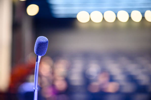 Microphone over the blurred business forum Meeting or Conference Room Concept, Blurred background.