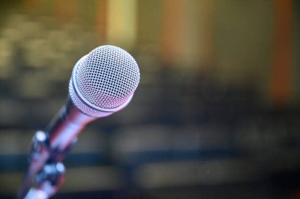 istock Microphone over the blurred business forum Meeting or Conference Room Concept, Blurred background. 1163101448