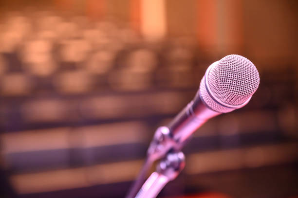 istock Microphone over the blurred business forum Meeting or Conference Room Concept, Blurred background. 1163101472