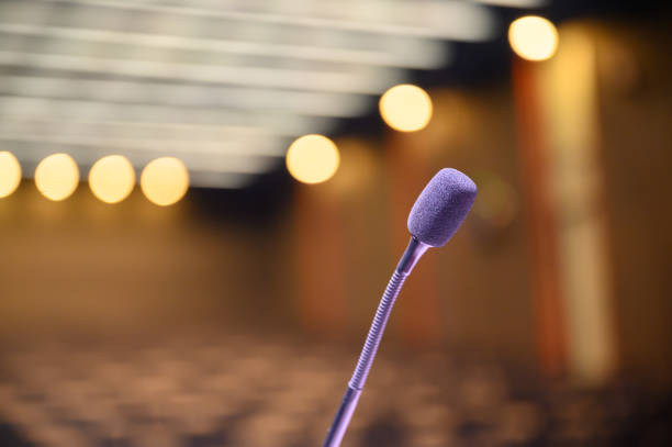 istock Microphone over the blurred business forum Meeting or Conference Room Concept, Blurred background. 1163101485