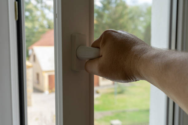 istock hand opening a window. Ventilating a house in hot weather. 1163105099
