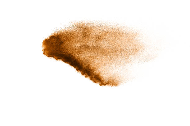 istock Abstract  brown color sand splash on white background. Brown dust particles explosion on background, throwing freeze stop motion concept. 1163105573