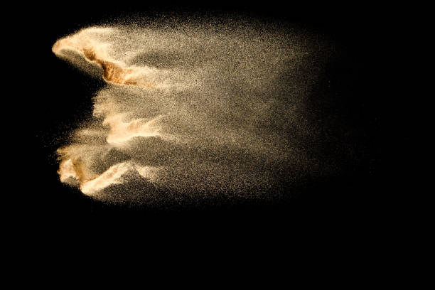 istock Abstract sand cloud.Golden colored sand splash agianst dark background.Yellow sand fly wave in the air. Sand explode on black background ,throwing freeze stop motion concept. 1163105574