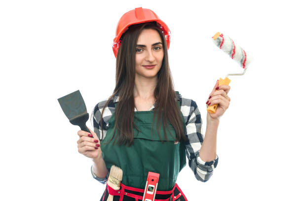 istock Girl holding painting tools isolated on white 1163105741
