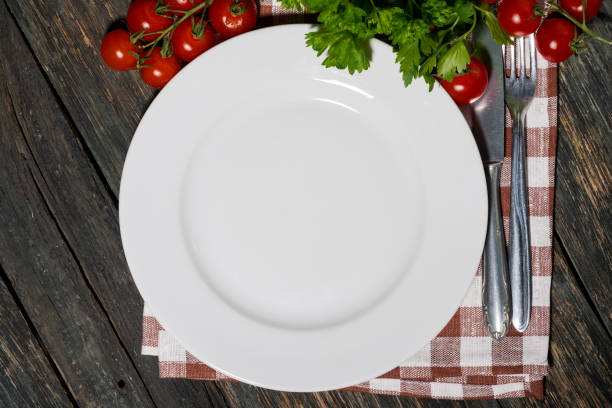 istock table setting with white plate and vegetables on wooden table, top view 1163108441