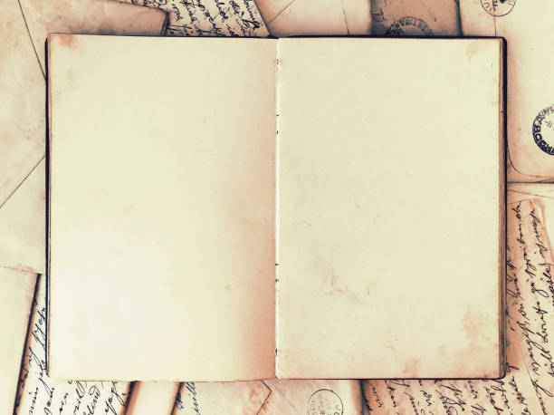 istock Open blank vintage journal on vintage letters 1163108812