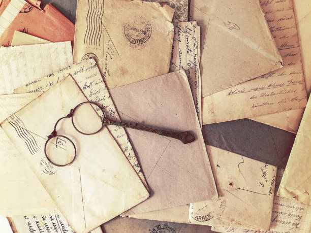 istock Vintage eyeglasses over old papers and letters 1163109764