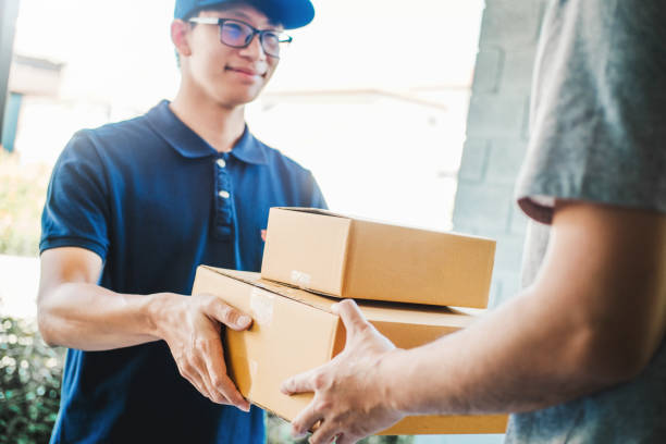 istock Asian Man hand accepting a delivery boxes from professional deliveryman at home 1163111037