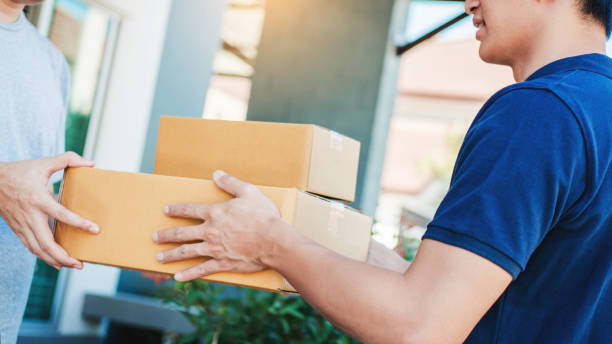 istock Asian Man hand accepting a delivery boxes from professional deliveryman at home 1163111073