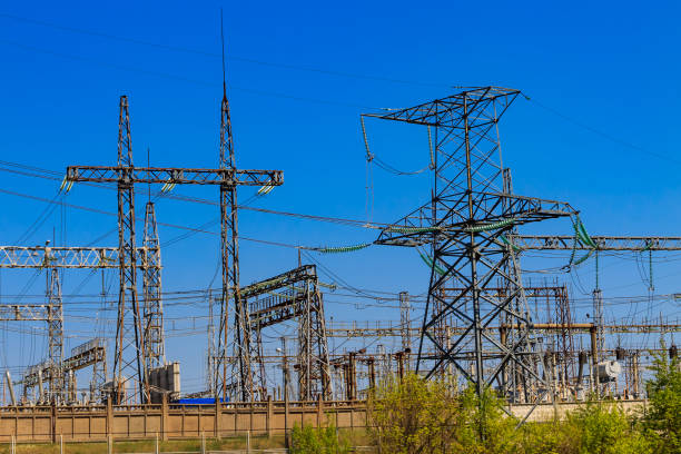istock High voltage power lines towers on blue sky background 1163111702