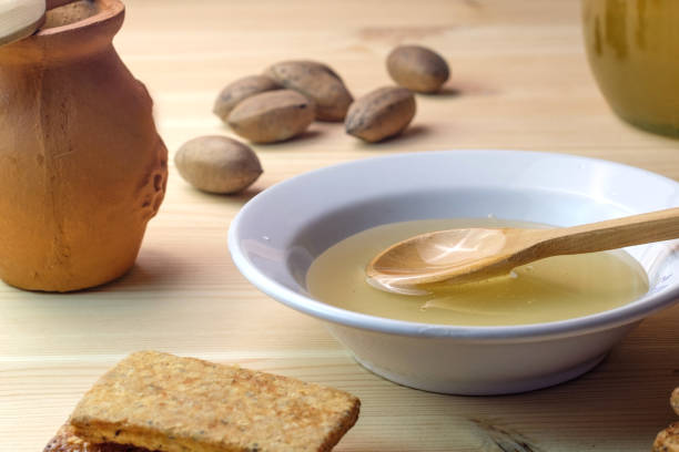 istock ceramic plate with honey in a clay pot lay next to walnuts 1163115085