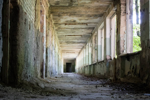 istock corridor in the destroyed building 1163115715