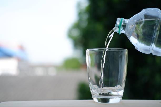 istock close up pouring drinks water on counter 1163119581