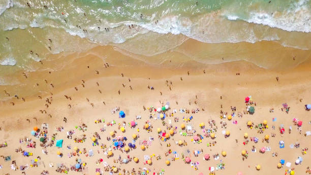 istock Crowded public beach with colourful umbrellas 1163120327