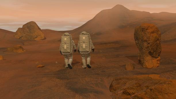 istock 3D rendering. Colony on Mars. Two Astronauts Wearing Space Suit Walking On The Surface Of Mars. 1163121501