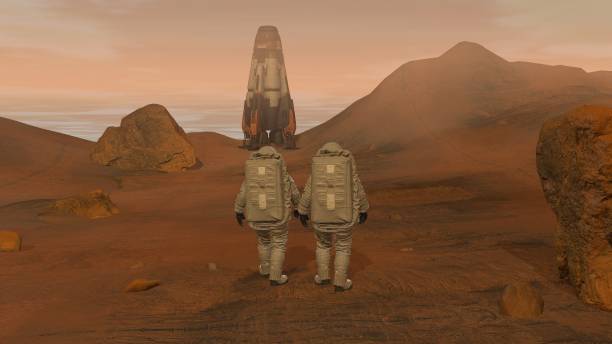 istock 3D rendering. Colony on Mars. Two Astronauts Wearing Space Suit Walking On The Surface Of Mars. 1163121524
