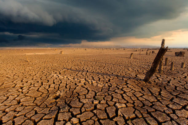 istock thunder storm sky Rain clouds Cracked dry land 1163122868
