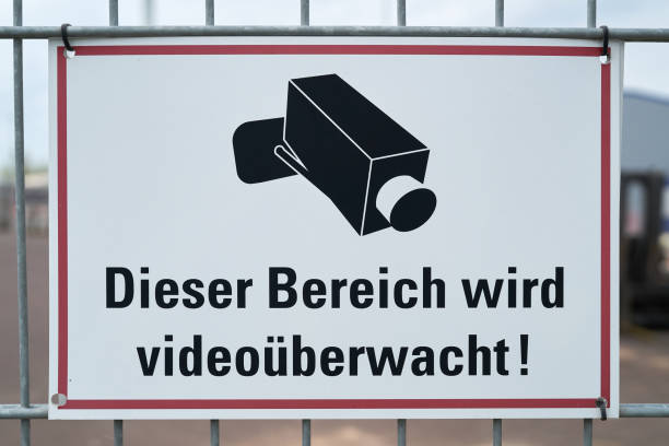 This area is video monitored Sign with the inscription "This area is video monitored" at a fence in Germany surveillance camera sign stock pictures, royalty-free photos & images