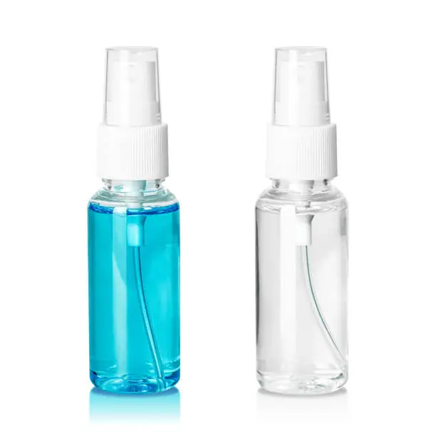 Photo of Spray bottle containing liquid inside isolated on white background. Plastic package with cosmetic cleaning product. ( Clipping path )