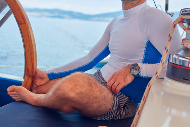 istock Sailor using wheel to steer rudder on a sailing boat. 1163124177
