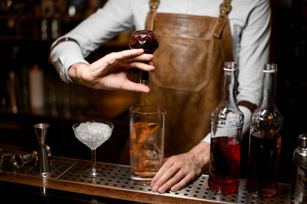 istock Bartender adding an essence from the little glass bottle 1163126065