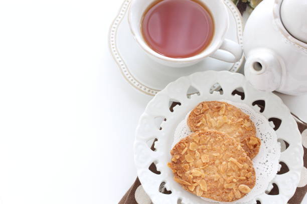 Snack with cookies ,melted chocolate in a cup and tea infusion in a glass with ice . Delicious break at home for a sweet snack
