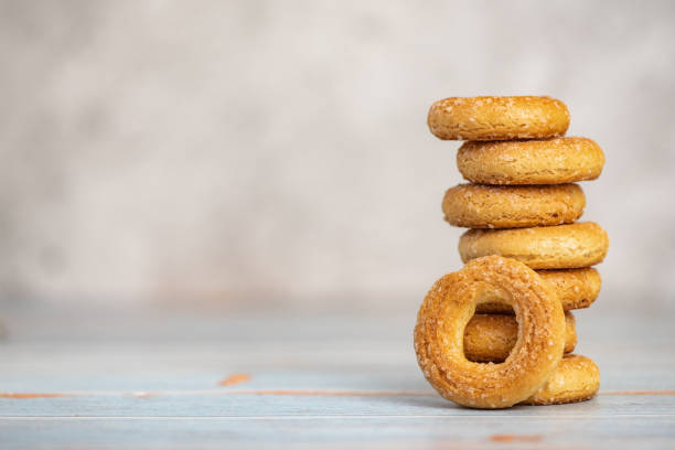 istock Stack of small sweet bagels on light background. With copy space 1163127191