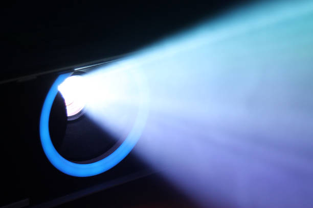 istock lue rays of light through the smoke from the projector 1163128420
