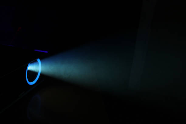 istock lue rays of light through the smoke from the projector 1163128422