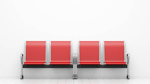 red waiting chairs in front of white wall