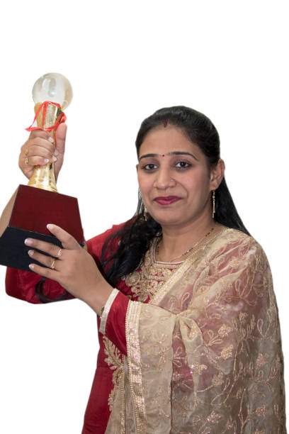 istock Woman lifting her winner trophy 1163131666