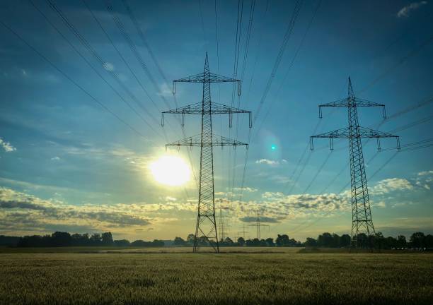 istock Beautiful landscape view at rising sun in germany with power grid 1163132508