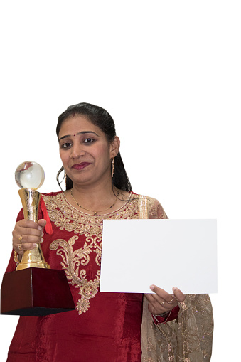 Happy Indian woman holding winner trophy and showing certificate