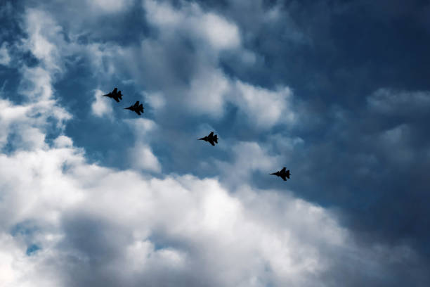 istock silhouette of fighters in the sky 1163133019
