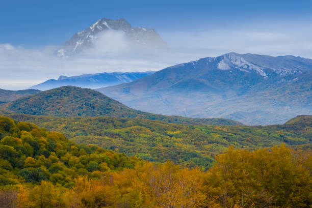 istock red autumn mountain valley below the high mount peak in a snow 1163134775