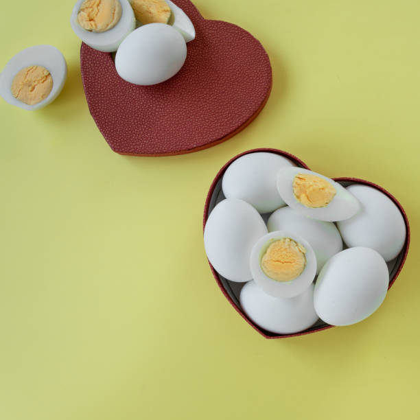 istock Healthy eating - eggs in heart shaped box on yellow background 1163138007