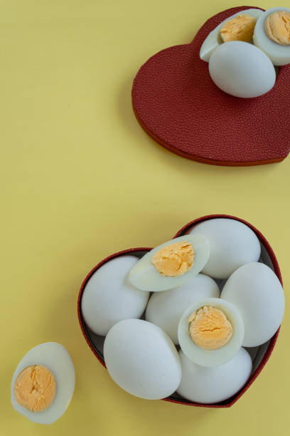 istock Healthy eating - eggs in heart shaped box on yellow background 1163138644