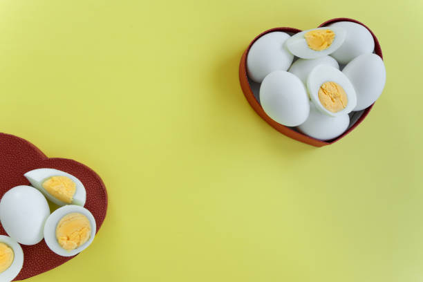 istock Healthy eating - eggs in heart shaped box on yellow background 1163138646