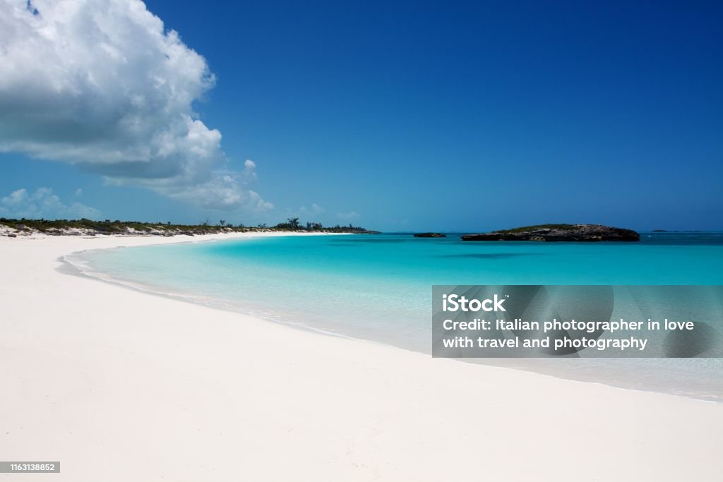 White sand beach and clear turquoise water in the Exuma island, Bahamas Caribbean typical seascape: secluded white sand beach with incredible turquoise clear water, Exuma island, Bahamas Bahamas Stock Photo