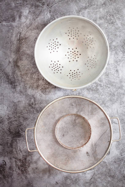istock Metalic colanders. Kitchen utensils. Eco friendly Zero waste plastic free kitchen on gray  background. concept sustainable lifestyle or Recycling and ecology. 1163139043
