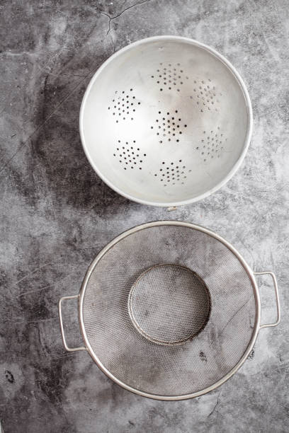 istock Metalic colanders. Kitchen utensils. Eco friendly Zero waste plastic free kitchen on gray  background. concept sustainable lifestyle or Recycling and ecology. 1163139097