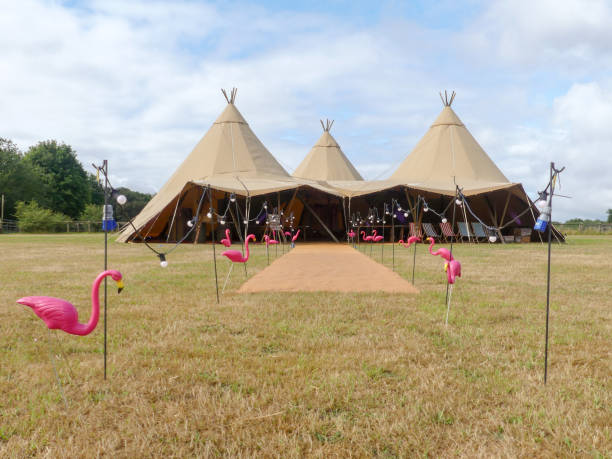 three large tepees set up for a wedding event on farmland - teepee imagens e fotografias de stock
