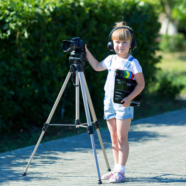 istock Child novice video blogger with a camera and a tripod. 1163143990