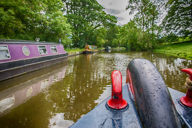 istock Narrowboats on a British canal in rural setting 1163144619