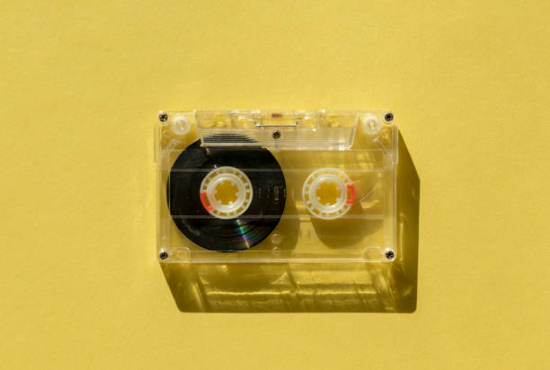 istock retro transparent audio cassette with copy space for text on yellow background. 1163145535