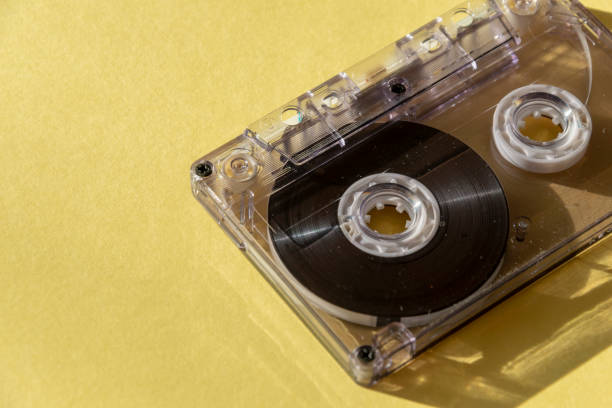 istock retro transparent audio cassette with copy space for text on yellow background. 1163145541