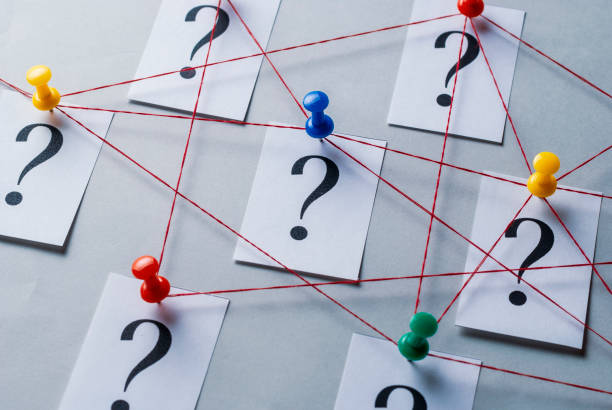 istock Network of printed question marks on white cards 1163145570