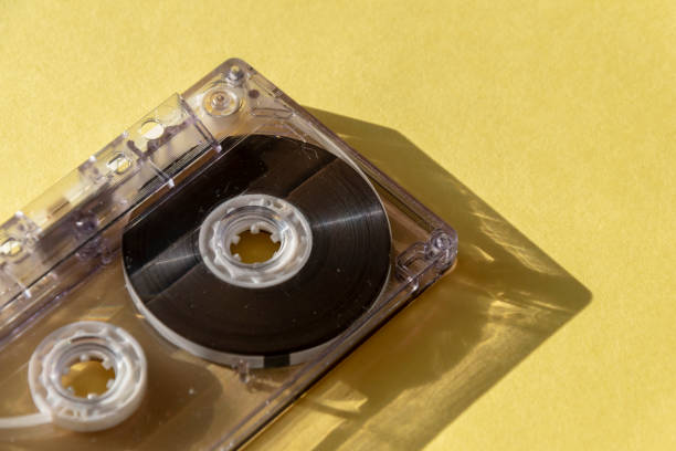 istock retro transparent audio cassette with copy space for text on yellow background. 1163145600