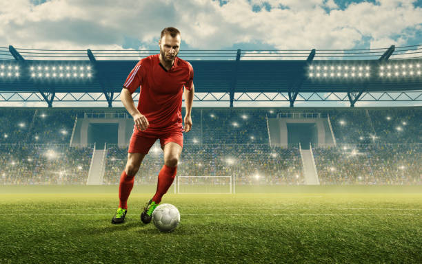 istock Soccer player dribbles a ball on a stadium 1163147260